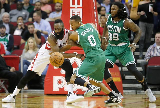 Nov 16, 2015; Houston, TX, USA; Houston Rockets guard James Harden (13) and Boston Celtics guard Avery Bradley (0) fight for a loose ball in the second quarter at Toyota Center. Mandatory Credit: Thomas B. Shea-USA TODAY Sports