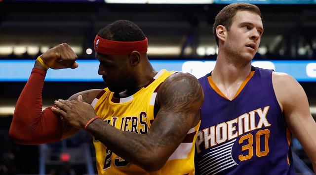 PHOENIX, AZ - DECEMBER 28:  LeBron James #23 of the Cleveland Cavaliers flexes after scoring and drawing a foul past Jon Leuer #30 of the Phoenix Suns during the first half of the NBA game at Talking Stick Resort Arena on December 28, 2015 in Phoenix, Arizona.  NOTE TO USER: User expressly acknowledges and agrees that, by downloading and or using this photograph, User is consenting to the terms and conditions of the Getty Images License Agreement.  (Photo by Christian Petersen/Getty Images)