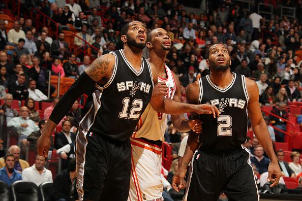 MIAMI, FL - FEBRUARY 9:  LaMarcus Aldridge #12 of the San Antonio Spurs and Kawhi Leonard #2 of the San Antonio Spurs boxes out against Chris Bosh #1 of the Miami Heat during the game on February 9, 2016 at American Airlines Arena in Miami, Florida. NOTE TO USER: User expressly acknowledges and agrees that, by downloading and or using this Photograph, user is consenting to the terms and conditions of the Getty Images License Agreement. Mandatory Copyright Notice: Copyright 2016 NBAE (Photo by Issac Baldizon/NBAE via Getty Images)