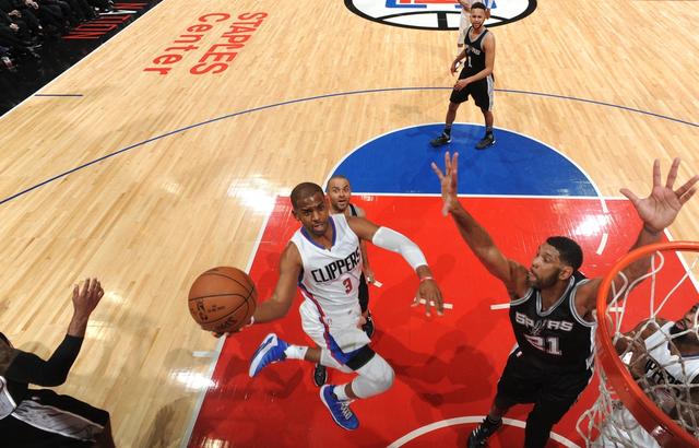 LOS ANGELES, CA - FEBRUARY 18:  Chris Paul #3 of the Los Angeles Clippers goes to the basket against Tim Duncan #21 of the San Antonio Spurs on February 18, 2016 at STAPLES Center in Los Angeles, California. NOTE TO USER: User expressly acknowledges and agrees that, by downloading and/or using this Photograph, user is consenting to the terms and conditions of the Getty Images License Agreement. Mandatory Copyright Notice: Copyright 2016 NBAE (Photo by Andrew D. Bernstein/NBAE via Getty Images)
